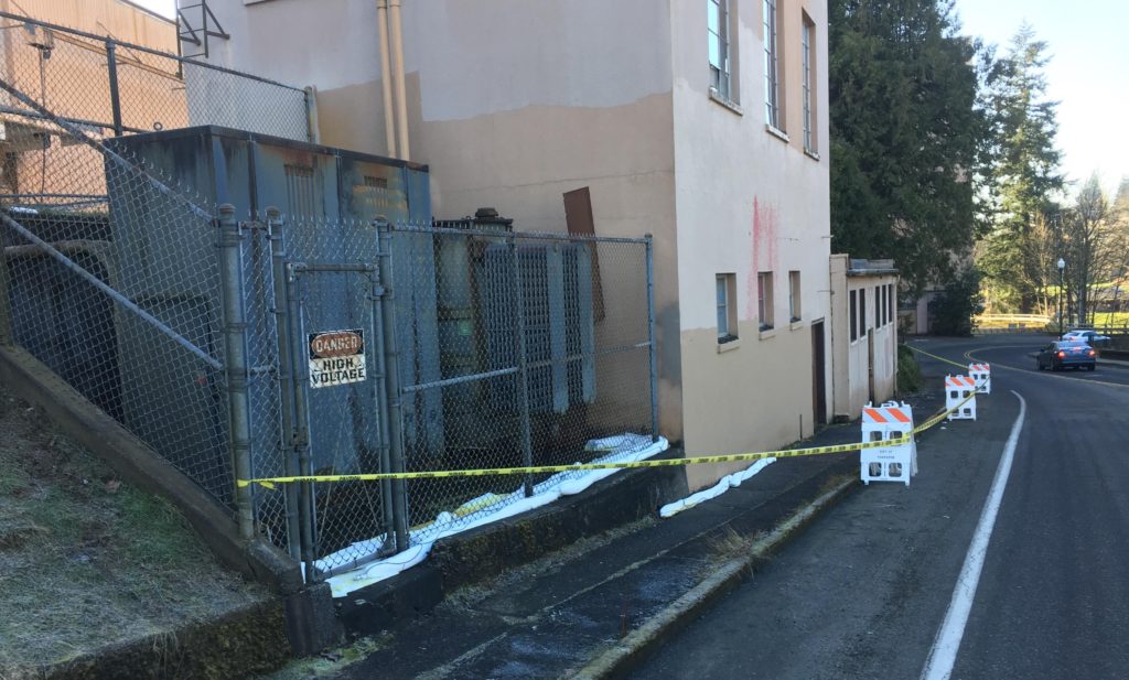 This transformer, seen behind the cyclone fence, leaked oil at the former Olympia Brewery site. Approximately 600 gallons of oil entered the Deschutes River and Capitol Lake.  (Photo Courtesy of Department of Ecology) 